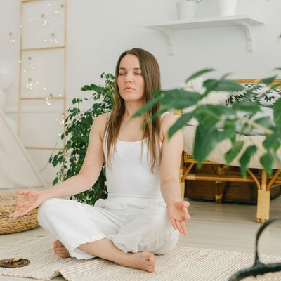A person sitting calmly with eyes closed in a meditation pose.