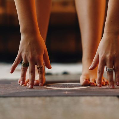 Close-up of hands in a graceful, flowing yoga posture.